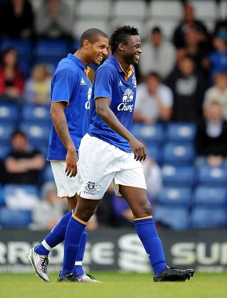 Everton's Magaye Gueye and Jermaine Beckford: A Celebratory Moment after Gueye's First Goal in the 2011 Pre-Season Friendly against Bury