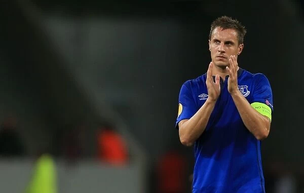 Everton's Phil Jagielka Celebrates UEFA Europa League Victory Over Lille OSC with Fans