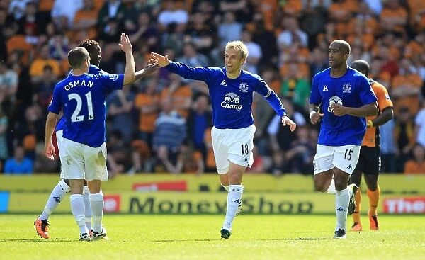 Everton's Phil Neville Scores and Celebrates with Team-mates in Barclays Premier League Victory over Wolverhampton Wanderers (09 April 2011)