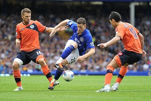 Everton's Ross Barkley Faces Off Against Faurlin and Buzsaky of QPR in Intense Premier League Clash (2011)