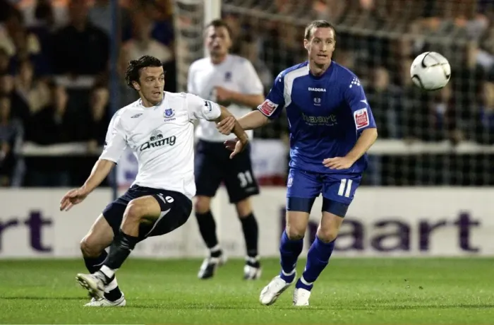 Framed Print : Evertons Simon Davies and Peterbroughs Peter Gain in action