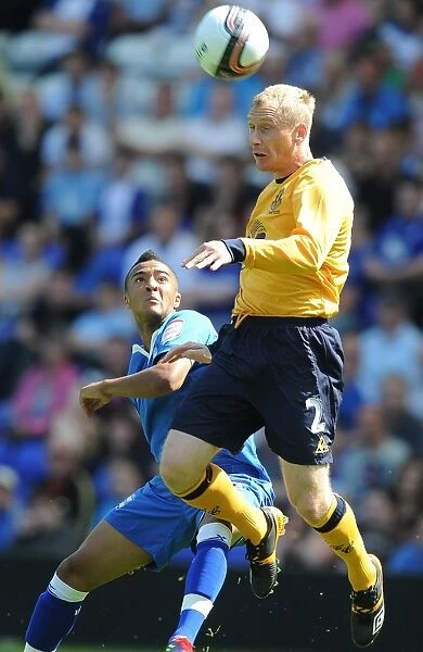 Everton's Tony Hibbert Defies Gravity: Soaring Above Birmingham's Nathan Redmond in Pre-Season Clash