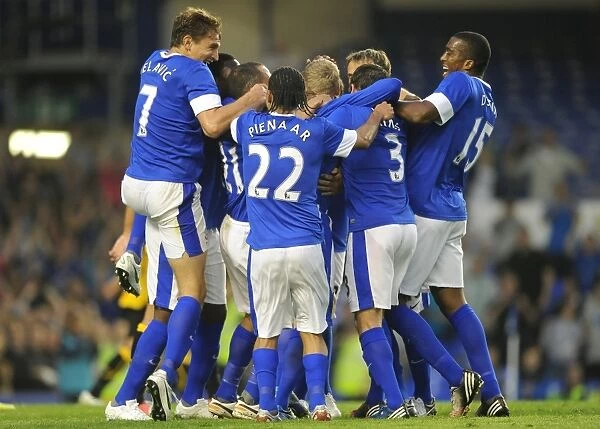 Everton's Tony Hibbert: A Euphoric Moment of Victory Amidst Jubilant Team Mates (Everton vs AEK Athens, Pre-Season Friendly, Goodison Park)
