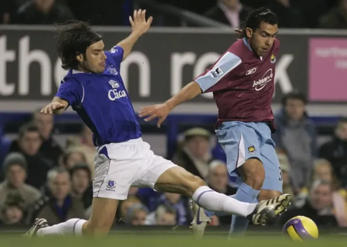 Framed Print : Evertons Valente challenges West Ham Uniteds Tevez for the ball during their English Premier Leagu