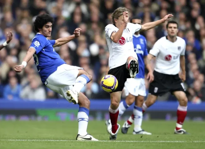 Framed Print : Fellaini vs Bullard: Intense Clash Between Everton's Marouane Fellaini and Fulham's Jimmy Bullard in Premier League Football Framed Print : Fellaini vs Bullard: Intense Clash Between Everton's Marouane Fellaini and Fulham's Jimmy Bullard in Premier League Football