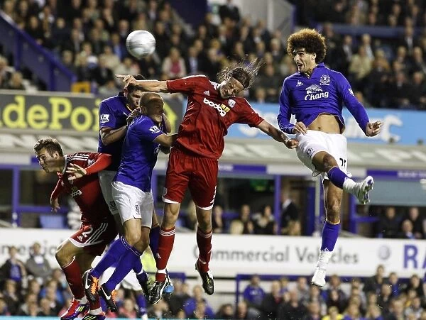 Fellaini vs. Olsson: A Battle for the Ball in Everton's Carling Cup Clash against West Bromwich Albion
