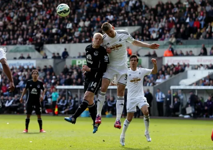 Framed Print : Fernandez vs. Naismith: A Battle of Determination in the Everton vs. Swansea City Premier League Clash at Liberty Stadium Framed Print : Fernandez vs. Naismith: A Battle of Determination in the Everton vs. Swansea City Premier League Clash at Liberty Stadium