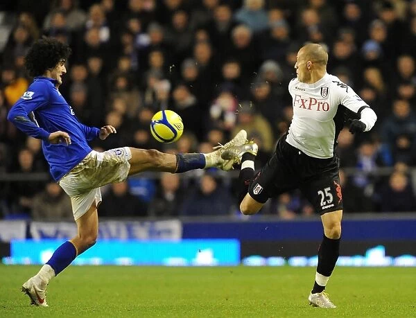 Fierce Rivalry: Marouane Fellaini vs. Bobby Zamora - Everton vs. Fulham's Intense FA Cup Battle for the Ball