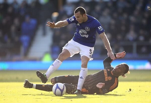 Heating Up the Pitch: A Fierce Battle Between Heitinga and Drogba in the FA Cup Fourth Round Clash between Everton and Chelsea (29 January 2011)