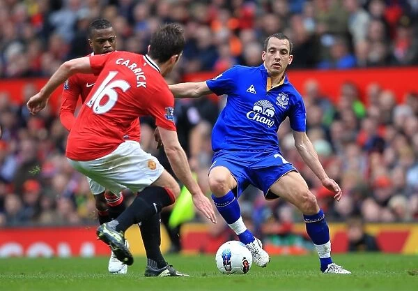 Intense Battle for Ball Possession: Carrick vs. Osman - Manchester United vs. Everton (April 2012, Old Trafford)