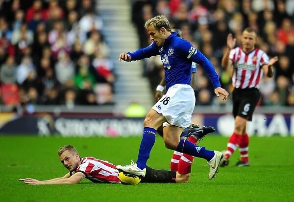 Intense Moment: Phil Neville Stops Sebastian Larsson's Goal Attempt in Sunderland vs. Everton (December 2011)