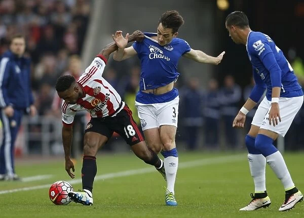 Intense Rivalry: Baines vs Defoe Battle for Ball - Sunderland vs Everton, Premier League