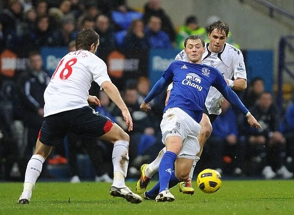 Intense Rivalry: Coleman vs. Ricketts Battle for Ball - Everton vs. Bolton Wanderers, Premier League (February 13, 2011)