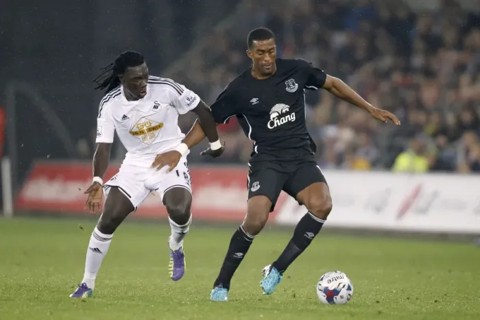 Framed Print : Intense Rivalry: Distin vs. Gomis Battle for Ball Supremacy in Swansea City vs. Everton's Capital One Cup Clash Framed Print : Intense Rivalry: Distin vs. Gomis Battle for Ball Supremacy in Swansea City vs. Everton's Capital One Cup Clash