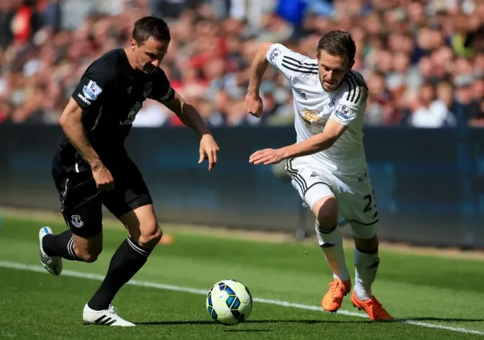 Framed Print : Intense Rivalry: Jagielka vs. Sigurdsson Battle at Swansea City vs. Everton (Barclays Premier League) Framed Print : Intense Rivalry: Jagielka vs. Sigurdsson Battle at Swansea City vs. Everton (Barclays Premier League)