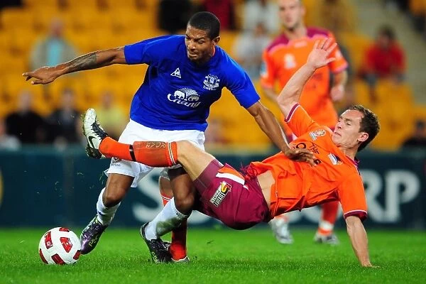 Intense Rivalry: Jermaine Beckford vs Matt Smith Battle for Ball at Suncorp Stadium - Everton vs Brisbane Roar
