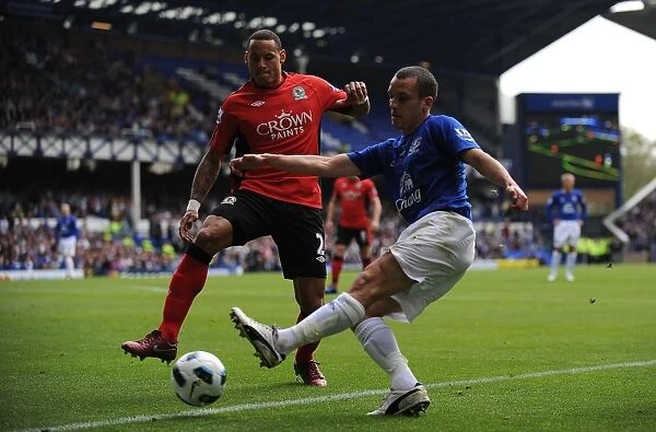 Intense Rivalry: Osman vs. Jones - A Battle for Ball Possession, Everton vs. Blackburn Rovers, Barclays Premier League (16 April 2011, Goodison Park)