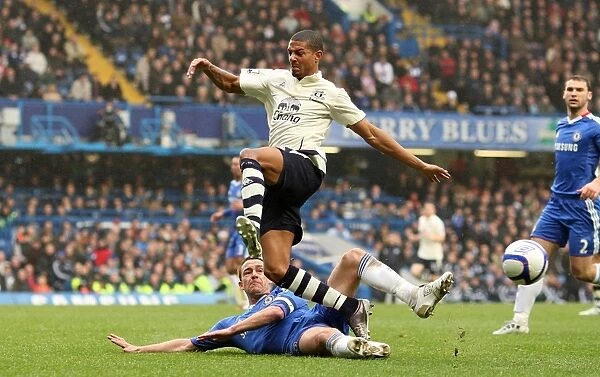 Jermaine Beckford vs John Terry: A FA Cup Battle at Stamford Bridge - Everton's Determined Forward Takes on Chelsea's Defensive Legend (Fourth Round Replay, 19 February 2011)