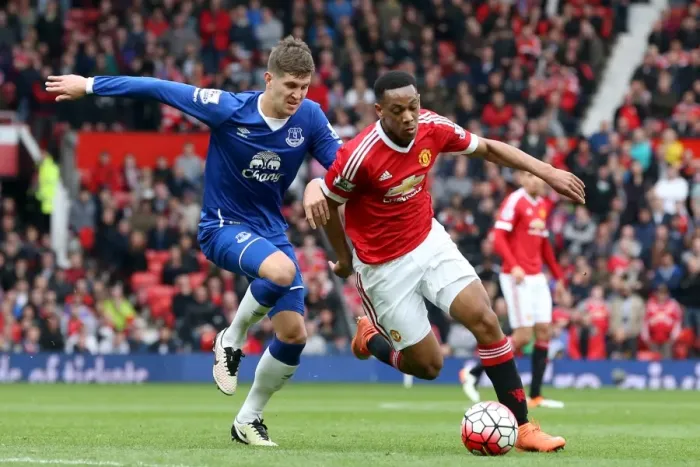 Framed Print : Manchester United vs. Everton: John Stones and Anthony Martial Clash in Barclays Premier League Match Framed Print : Manchester United vs. Everton: John Stones and Anthony Martial Clash in Barclays Premier League Match