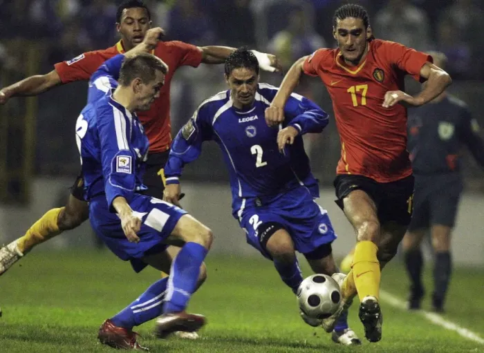 Framed Print : Marouane Fellaini-Bakkioui of Belgium is challanged by Bosnias Boris Pandza and Dzemal Berberovic during their 2010 World Cup qualifying soccer match in Zenica