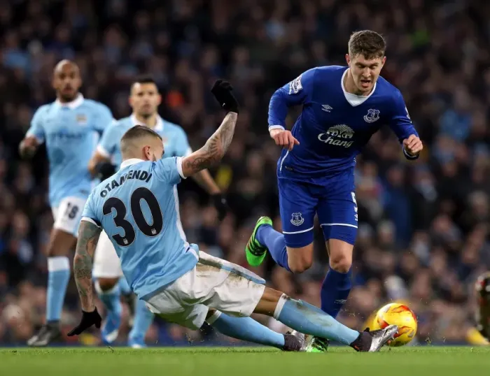 Framed Print : Otamendi vs. Stones: A Battle for Supremacy in the Capital One Cup Semi-Final Clash between Manchester City and Everton