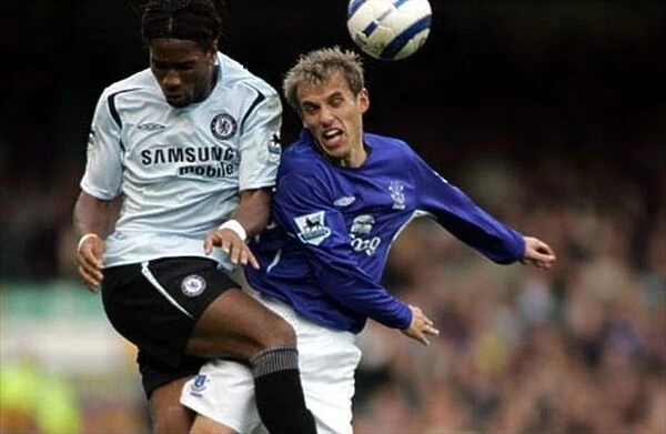 Phil Neville is challenged by Didier Drogba