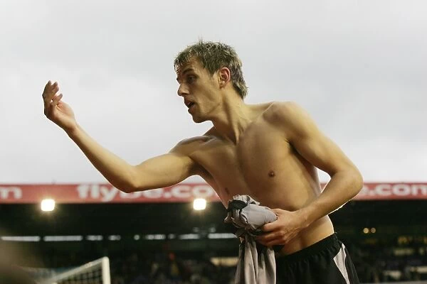 Phil Neville prepares to throw his shirt to fans