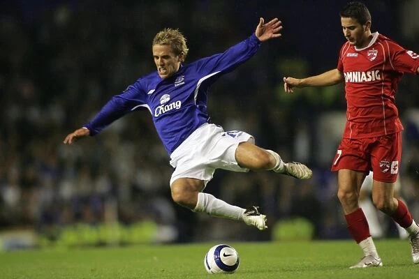 Phil Neville is sent flying by a Dinamo challenge