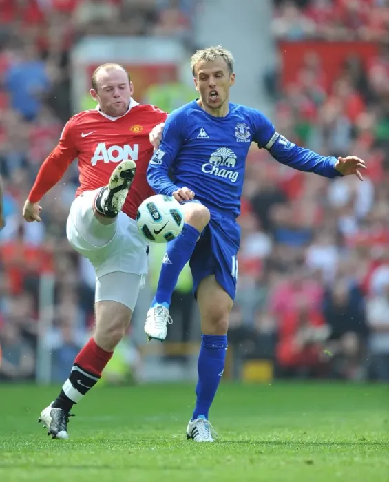 Framed Print : Rooney vs Neville: Clash of Blues and Reds at Old Trafford - Manchester United vs Everton, Barclays Premier League (23 April 2011)