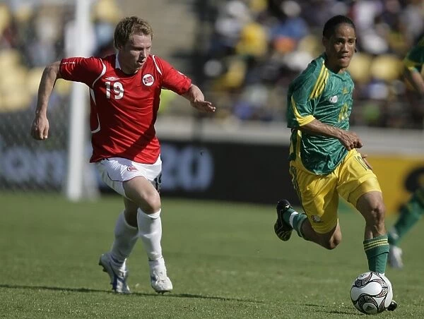 South Africas Pienaar controls the ball from Norways Riise during the Nelson Mandela soccer challenge in Rusternburg