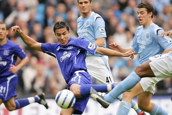 Tim Cahill. Cahill gets in a shot despite the attention of a host of City defenders