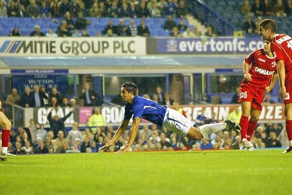 Tim Cahill dives and heads home