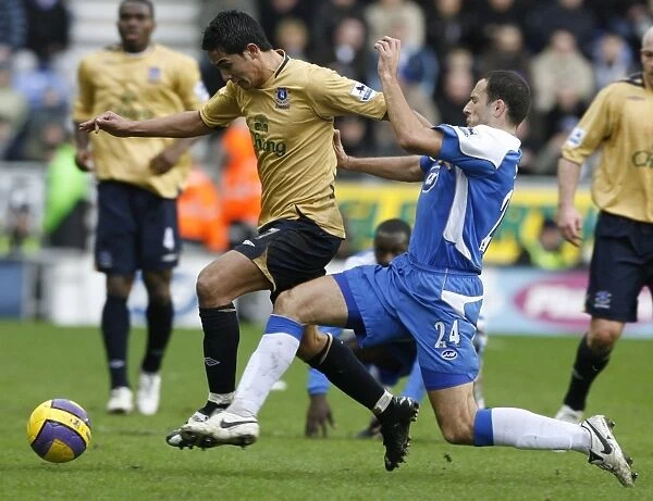Wigan Athletics Skoko challenges Evertons Cahill for the ball during their English Premier League