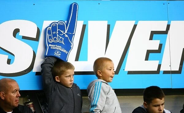 Young Everton Fan Waves Giant Foam Hand at Throbbing Goodison Park During Everton vs Stoke City, Barclays Premier League (2010)