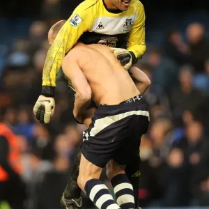 Celebrating Glory: Heitinga and Howard's FA Cup Upset Victory Jubilation at Stamford Bridge (19 February 2011)