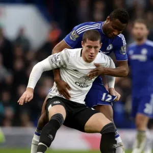 Clash at Stamford Bridge: A Battle for the Ball between Mikel John Obi and Ross Barkley (Premier League Showdown) Clash at Stamford Bridge: A Battle for the Ball between Mikel John Obi and Ross Barkley (Premier League Showdown)