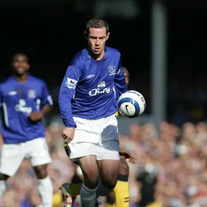 David Weir: Guarding Everton's Turf - Shielding the Ball from Wigan's Advance David Weir: Guarding Everton's Turf - Shielding the Ball from Wigan's Advance
