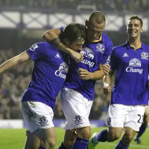 Everton's Baines Scores Penalty, Celebrates with Heitinga and Vellios: A Triumphant Moment at Goodison Park (19 November 2011 vs. Wolverhampton Wanderers) Everton's Baines Scores Penalty, Celebrates with Heitinga and Vellios: A Triumphant Moment at Goodison Park (19 November 2011 vs. Wolverhampton Wanderers)