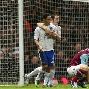 Everton's Double Strike: Pienaar and Baines Celebrate as Collins Looks On in Disappointment (Everton 2-1 West Ham, Upton Park, 2012)