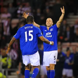 Everton's Glory: Distin and Heitinga Celebrate FA Cup Sixth Round Replay Victory over Sunderland Everton's Glory: Distin and Heitinga Celebrate FA Cup Sixth Round Replay Victory over Sunderland