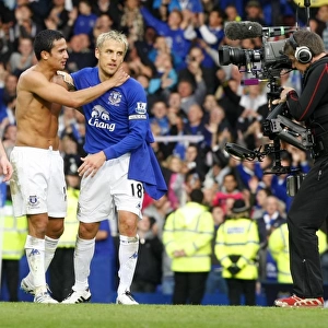 Everton's Glory: Tim Cahill and Phil Neville's Derby Victory Celebration at Goodison Park