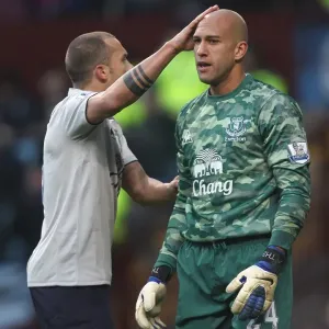 Everton's Heitinga Comforts Howard: A Moment of Solidarity on the BPL Battlefield (14 January 2012, Aston Villa vs. Everton) Everton's Heitinga Comforts Howard: A Moment of Solidarity on the BPL Battlefield (14 January 2012, Aston Villa vs. Everton)