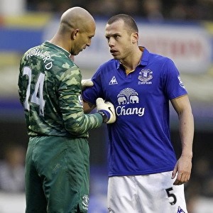 Everton's Howard and Heitinga Deep in Tactical Discussion at Goodison Park during Everton vs Chelsea (11 February 2012)