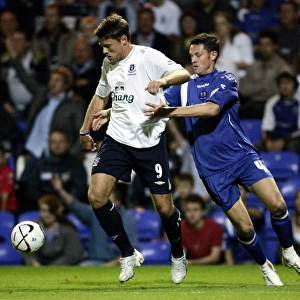 Evertons James Beattie and Peterbroughs Mark Arber in action