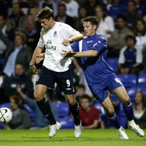 Evertons James Beattie and Peterbroughs Mark Arber in action