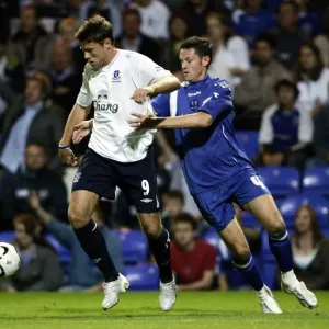 Evertons James Beattie and Peterbroughs Mark Arber in action Evertons James Beattie and Peterbroughs Mark Arber in action