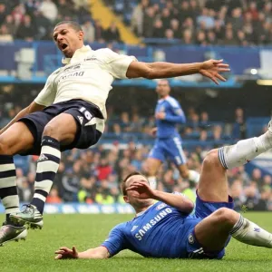 Everton's Jermaine Beckford vs Chelsea's John Terry: A FA Cup Battle at Stamford Bridge - Determined Striker vs Defiant Captain (February 19, 2011)