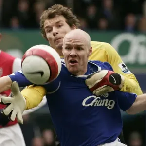 Evertons Johnson challenges Arsenals Lehmann for the ball during their English Premier League socc Evertons Johnson challenges Arsenals Lehmann for the ball during their English Premier League socc