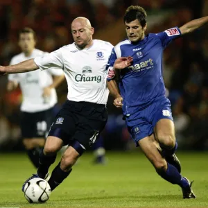 Evertons Lee Carsley and Peterbroughs Richard Butcher in action