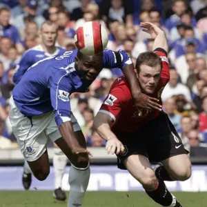 Evertons Yobo challenges Manchester Uniteds Rooney for the ball during their English Premier Leagu Evertons Yobo challenges Manchester Uniteds Rooney for the ball during their English Premier Leagu